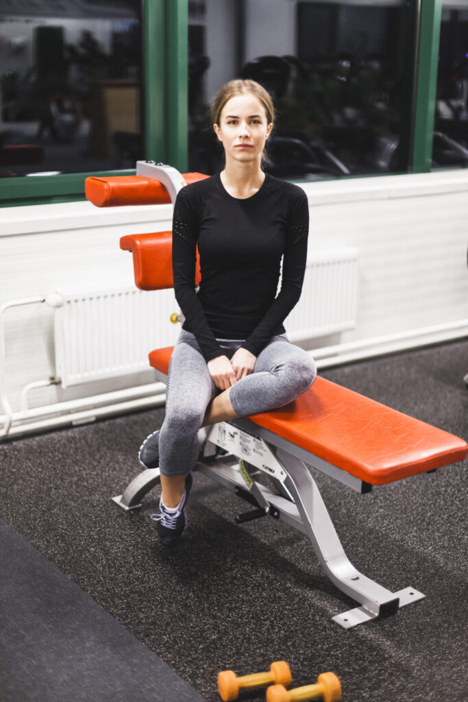 girl doing exercise on gym Bench at home 