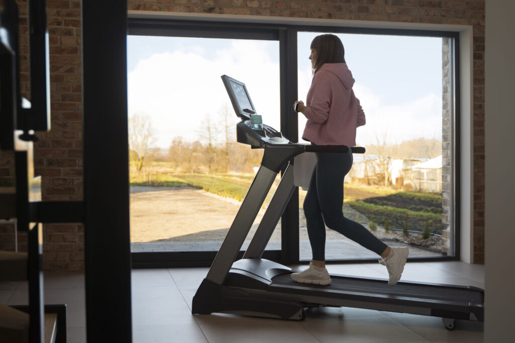 girl doing exercise on Treadmill at home 